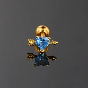 Gold heart arrow earring with blue zircon stone and screw back on black mirror background
