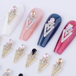 Macro view of crystal rhinestones on triangular alloy bases for 3D nail art design