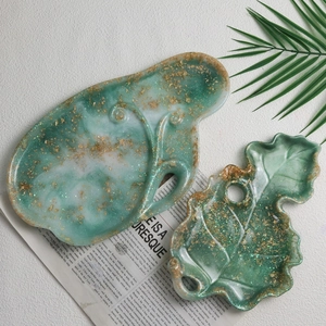 Irregular emerald green and white resin tray set with gold leaf flakes and fluid patterns