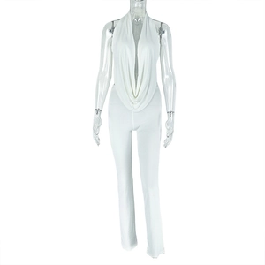 Detail of white halter neck jumpsuit showing deep V-neckline and slim fit long trousers
