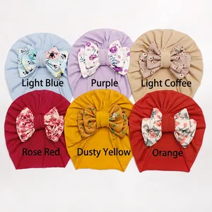 Set of six baby bow turban hats with floral prints in light blue, purple, and warm colors