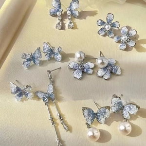 Silver needle earrings with blue butterfly floral glass beads and pearls in a fresh summer style