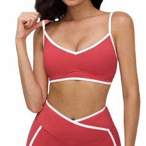 Coral red v-neck sports bra and high-waisted leggings set with white contrast trim
