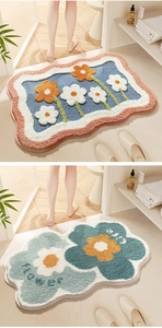 Detailed plush texture of floral bathroom mats in blue and orange floral patterns