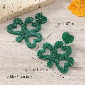 Detail showing St. Patrick's Day green glitter clover earrings with size measurements