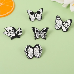 Detailed view of punk moth and skull enamel pins set with gothic butterfly designs