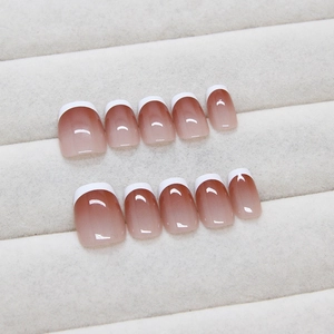 Classic white French tip and nude pink gradient press-on nails in a 10-piece set