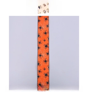 Detail of orange Halloween ribbon featuring black spider and cobweb prints with stitched edges