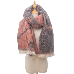 Detailed view of orange and grey checkered knit scarf with soft tassel fringe edges
