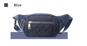 Close-up of blue quilted crossbody bag featuring diamond stitching and plastic buckle