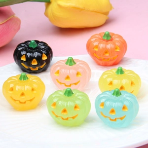 Close-up of seven colorful 3D luminous Halloween resin pumpkins on a white plate