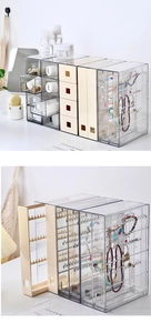 Macro detail of clear acrylic jewelry organizer with sliding hooks and dustproof drawers