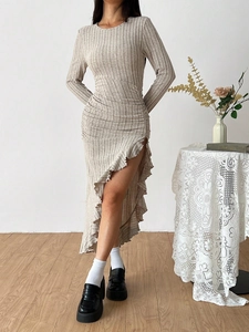 Detail of oatmeal ribbed knit dress featuring ruched front and ruffled slit hem detail