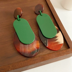 Detailed view of vintage geometric resin earrings in dark green and amber marble finish