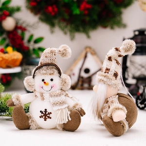 Detail of knitted snowman and gnome plush decorations with brown faux fur textures