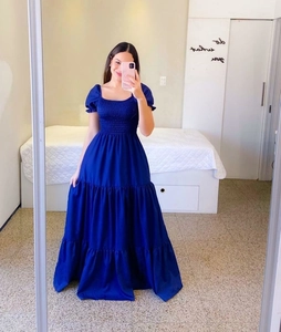 Detail of navy blue smocked bodice with off-the-shoulder puff sleeves on maxi dress