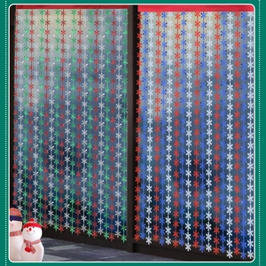 Close-up of reflective snowflake foil curtains in red green and white for party decor