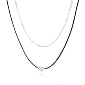 Double-layered necklace with black cord, silver chain and heart pendant on white background