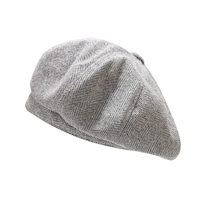 British style grey herringbone tweed newsboy cap for men and women on white background