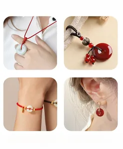 Close-up of white and red jade-style pendant necklaces and bracelets on model