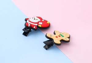Detailed view of Christmas Santa and Gingerbread Man soft PVC hair clips on metal duckbill clips