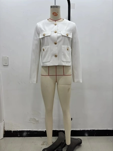 Detailed view of white tweed jacket featuring elegant gold buttons and four flap pockets