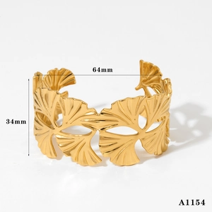 Detail view of 34mm wide gold hollowed ginkgo leaf cuff bracelet with 64mm diameter