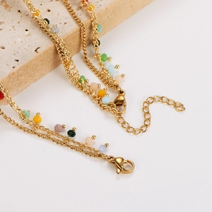 Colorful beaded gold layered bracelet with multi-color butterfly charms and lobster clasp