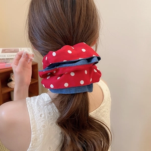 Close-up of double-layer polka dot scrunchie on a ponytail for a vintage sweet look