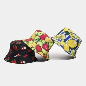 Detailed view of three cotton bucket hats with tropical fruit patterns and durable canvas