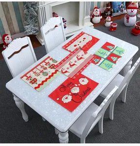 Set of five Christmas table mats with Santa and reindeer motifs on white stone table