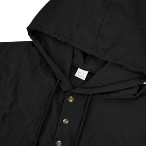 Macro detail of black linen hooded shirt neckline with drawstring and button closure