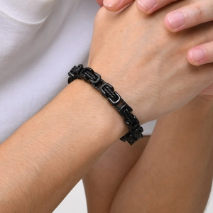 Macro shot of 8mm black stainless steel Byzantine chain bracelet on male wrist