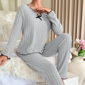 Grey ribbed lounge set with ruffled black trims and a decorative ribbon bow