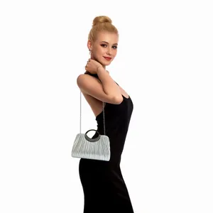 Detailed view of pleated silver evening clutch with rhinestone handle and chain