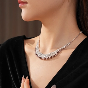 Detail of silver multi-row rhinestone fringe necklace showing elegant V-shape drop style
