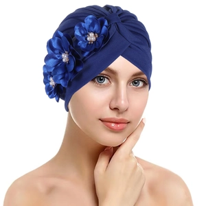 Detail of navy blue pleated headwrap with three silk flowers and pearl accents