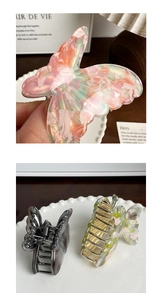 Detail of marble pattern butterfly hair claw clip with strong metal spring and teeth
