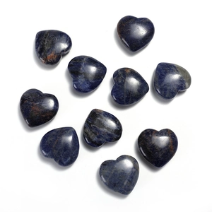 Polished blue sodalite heart-shaped stones with natural veins on a white background