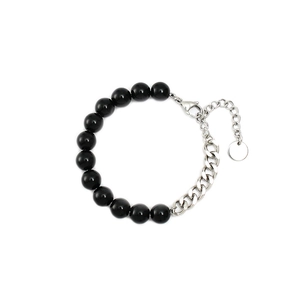 Detail of beaded bracelet with black rounds, silver chain, lobster clasp and tag