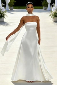 Close-up of elegant white satin strapless maxi dress with matching neck scarf detail