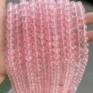 Close-up of translucent pink rose quartz beads with natural textures for DIY jewelry