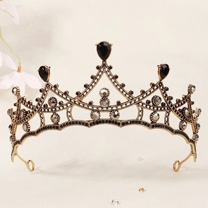 Detailed macro view of vintage gold bridal crown featuring black and grey crystals