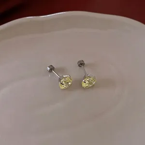 Elegant silver stud earrings featuring brilliant round yellow zircon stones in four-prong settings
