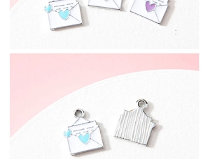 Macro view of heart envelope enamel alloy pendants showing front details and textured back side