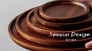 Close-up of stacked round wooden trays in various sizes held by hands