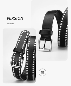 Detailed macro view showing silver metal rivets and square buckle on black leather belt