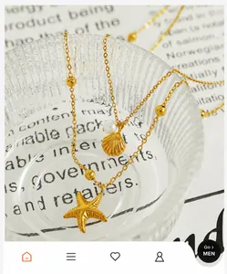 Detailed close-up of 18K gold starfish and shell pendants with pearl on a beaded chain