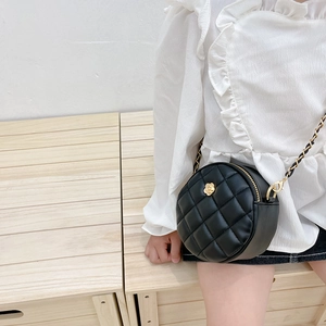 Black quilted round crossbody bag for girls with gold floral buckle and chain strap