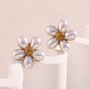Macro view of 18K gold plated flower earrings with five white faux pearl petals